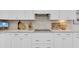 Close-up of a kitchen with light countertops, white subway tile, and white cabinets at 3885 Villamore Ln, Odessa, FL 33556