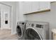 Well-equipped laundry room with modern washer and dryer, and ample storage cabinets, making laundry a breeze at 3885 Villamore Ln, Odessa, FL 33556