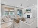 Bright living room with large sectional sofa, fireplace, and view to the outdoors at 3885 Villamore Ln, Odessa, FL 33556