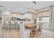 Open-concept kitchen and dining area with a stylish island, dining table, and modern light fixtures at 3885 Villamore Ln, Odessa, FL 33556