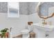 Stylish powder room with elegant mirror, wainscoting, and fixtures, a perfect blend of form and function at 3885 Villamore Ln, Odessa, FL 33556