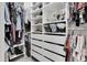 Organized walk-in closet with shelves, drawers, and hanging rods, maximizing storage space at 3885 Villamore Ln, Odessa, FL 33556
