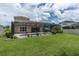 Lush green backyard with a screened-in patio, pool, and plenty of space for outdoor activities and relaxation at 4026 Bonfire Dr, Odessa, FL 33556