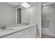 Bright bathroom featuring a double vanity with white cabinetry and a combined tub and shower with white tiling at 4026 Bonfire Dr, Odessa, FL 33556