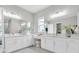 Bright bathroom features dual sinks with white cabinetry and large mirrors at 4026 Bonfire Dr, Odessa, FL 33556