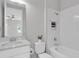 Bright bathroom features a vanity, toilet, and shower-tub combo with white tile at 4026 Bonfire Dr, Odessa, FL 33556