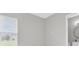 Light-filled bedroom showcasing a window with blinds and an ensuite bathroom at 4026 Bonfire Dr, Odessa, FL 33556