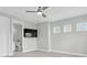 Bedroom featuring carpet, a ceiling fan, a wall-mounted TV, and an ensuite bathroom at 4026 Bonfire Dr, Odessa, FL 33556