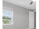 Bright bedroom featuring carpet, base molding and a window with neighborhood views at 4026 Bonfire Dr, Odessa, FL 33556