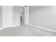 Carpeted bedroom with white doors and trim, showing an entryway with a view of the stairway at 4026 Bonfire Dr, Odessa, FL 33556