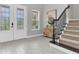 Inviting foyer with decorative glass door and staircase leading to the upper level at 4026 Bonfire Dr, Odessa, FL 33556