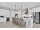 Bright and airy kitchen featuring a large center island, pendant lighting, and stainless steel appliances at 4026 Bonfire Dr, Odessa, FL 33556
