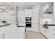 A modern kitchen with stainless steel appliances, white cabinets, and a spacious island at 4026 Bonfire Dr, Odessa, FL 33556