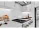 Bright kitchen with white cabinets, stainless steel appliances and herringbone tile backsplash at 4026 Bonfire Dr, Odessa, FL 33556