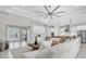 Spacious open-concept living room with modern lighting, and seamless flow to the kitchen at 4026 Bonfire Dr, Odessa, FL 33556