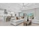 Open-concept living room with a large sofa, ceiling fan and easy access to the gourmet kitchen at 4026 Bonfire Dr, Odessa, FL 33556