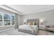 Serene main bedroom with large window and stylish gray upholstered headboard at 4026 Bonfire Dr, Odessa, FL 33556