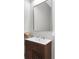 Stylish powder room features modern vanity with wood slat detail and decorative mirror at 4026 Bonfire Dr, Odessa, FL 33556