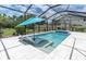 Inviting swimming pool and spa with in-pool loungers and a screened enclosure, perfect for relaxation at 4026 Bonfire Dr, Odessa, FL 33556