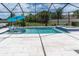 Enjoy the beautiful swimming pool, spa, and screened-in patio area with comfortable in-pool loungers at 4026 Bonfire Dr, Odessa, FL 33556