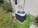 Image shows the air conditioner and surrounding yard of this lovely home at 4420 Sawgrass Blvd, New Port Richey, FL 34653