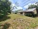 Large back yard with mature trees and screened in lanai at 4420 Sawgrass Blvd, New Port Richey, FL 34653
