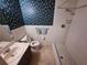Cozy bathroom featuring a vanity, toilet, decorative wallpaper, and walk-in shower at 4420 Sawgrass Blvd, New Port Richey, FL 34653