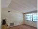 Bright bedroom featuring carpet flooring, a large window, and ample natural light at 4420 Sawgrass Blvd, New Port Richey, FL 34653