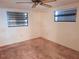 Bedroom with neutral colored walls, carpet and two windows for natural light at 4420 Sawgrass Blvd, New Port Richey, FL 34653