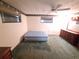 Spacious bedroom featuring a ceiling fan, two windows, and a vintage dresser at 4420 Sawgrass Blvd, New Port Richey, FL 34653
