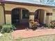 An inviting front entrance with a brick porch, arched entryways, and decorative plants at 4420 Sawgrass Blvd, New Port Richey, FL 34653