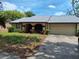Lovely one-story home featuring a well manicured yard and attached garage at 4420 Sawgrass Blvd, New Port Richey, FL 34653