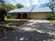 Charming single-story home with a two-car garage, manicured lawn, and inviting curb appeal at 4420 Sawgrass Blvd, New Port Richey, FL 34653