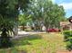 Beautifully landscaped front yard with mature trees and shrubs at 4420 Sawgrass Blvd, New Port Richey, FL 34653