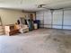 Attached garage with a roll-up door and space for storage or parking at 4420 Sawgrass Blvd, New Port Richey, FL 34653