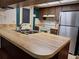 Kitchen with double sink, wooden countertops and cabinets, with a white stove at 4420 Sawgrass Blvd, New Port Richey, FL 34653