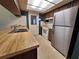 Bright kitchen offers a stainless steel refrigerator and a double sink at 4420 Sawgrass Blvd, New Port Richey, FL 34653