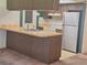 The kitchen boasts a breakfast bar, white appliances, and wood-look cabinetry at 4420 Sawgrass Blvd, New Port Richey, FL 34653