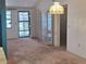 Open-concept living room with bright lighting, neutral walls, and carpet flooring at 4420 Sawgrass Blvd, New Port Richey, FL 34653