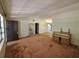 The carpeted living room includes a front door and a piano at 4420 Sawgrass Blvd, New Port Richey, FL 34653
