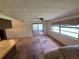 Living room with ceiling fan, large windows and access to a screened-in patio at 4420 Sawgrass Blvd, New Port Richey, FL 34653