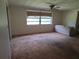 The living room offers a ceiling fan and a large window at 4420 Sawgrass Blvd, New Port Richey, FL 34653