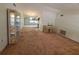 The living room has carpeted floors and provides access to other parts of the home at 4420 Sawgrass Blvd, New Port Richey, FL 34653