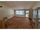 Spacious living room featuring large windows, neutral walls, and a secure front door at 4420 Sawgrass Blvd, New Port Richey, FL 34653