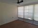 Enclosed sunroom with a ceiling fan, windows, and neutral colored carpet at 4420 Sawgrass Blvd, New Port Richey, FL 34653