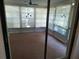 View of the sunroom with multiple windows and a fan at 4420 Sawgrass Blvd, New Port Richey, FL 34653