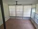 Enclosed sunroom featuring a ceiling fan and large windows for natural light at 4420 Sawgrass Blvd, New Port Richey, FL 34653