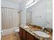 Bathroom featuring granite countertops with double vanity sinks and shower over tub at 4481 Birchfield Loop, Spring Hill, FL 34609