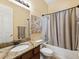 Well-lit bathroom features granite countertops, a shower-tub combo, and neutral decor at 4481 Birchfield Loop, Spring Hill, FL 34609