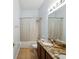 Bright bathroom featuring a shower over tub with a granite countertop vanity at 4481 Birchfield Loop, Spring Hill, FL 34609
